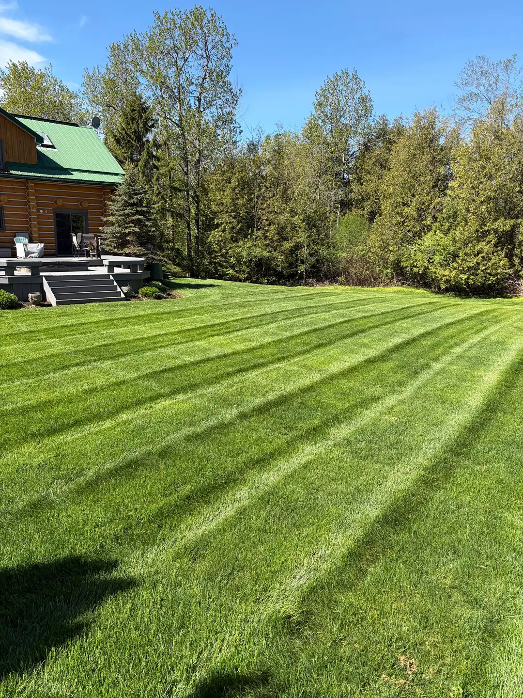 Manicured garden bed and healthy lawn at a Durham Region property