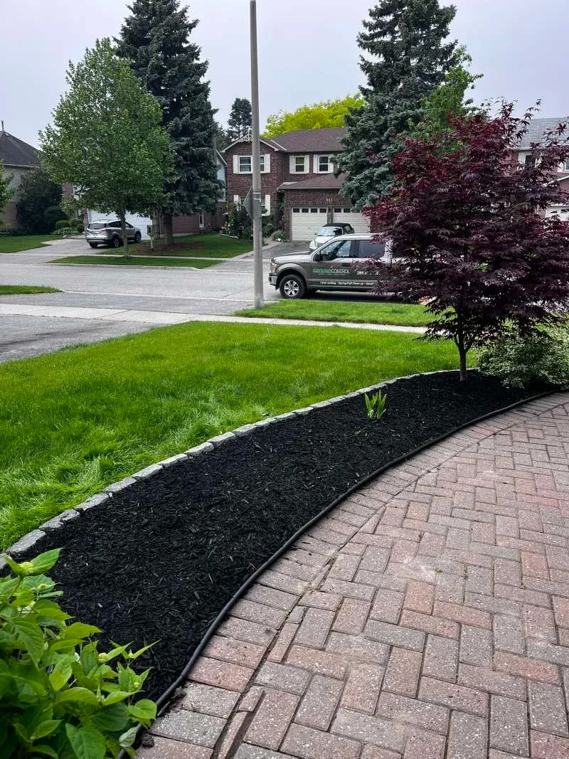 Professional de-weeding and fresh mulch installation in Whitby