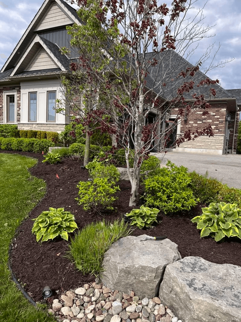 Professional mulch application to protect plants and improve curb appeal in Bowmanville
