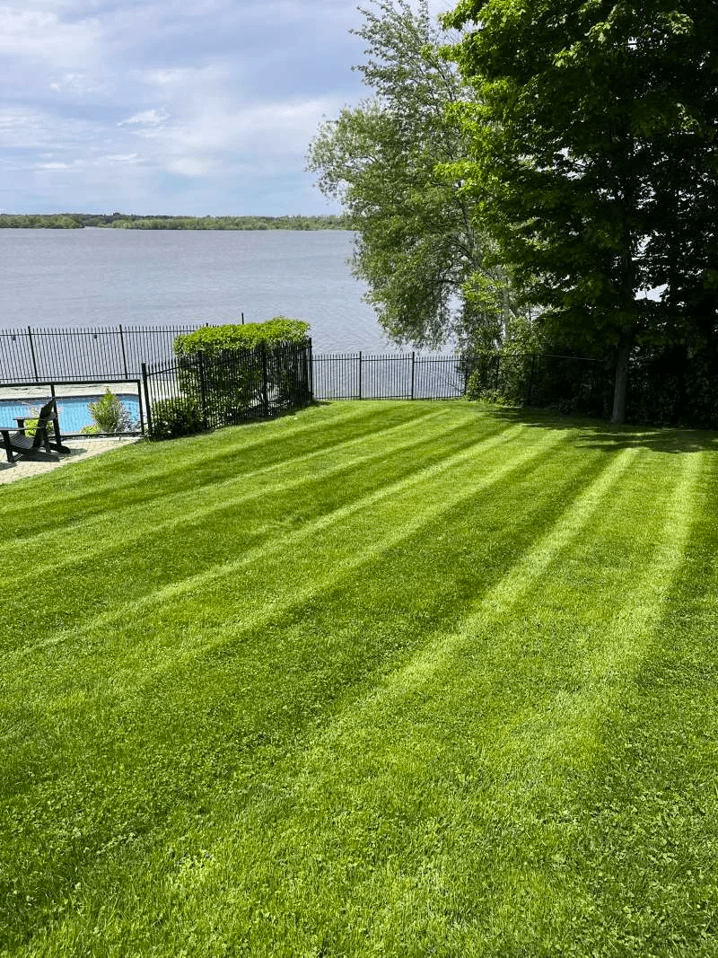 Professional lawn cutting and edging service for a large property in Port Perry