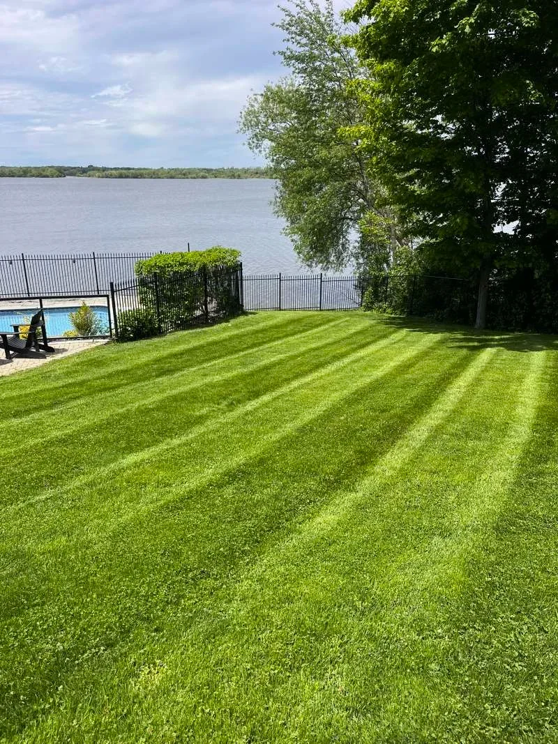 Professional lawn cutting and edging service for a large property in Port Perry