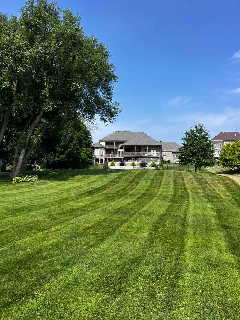 Professional weekly lawn cutting and edging service for a large property in Port Perry